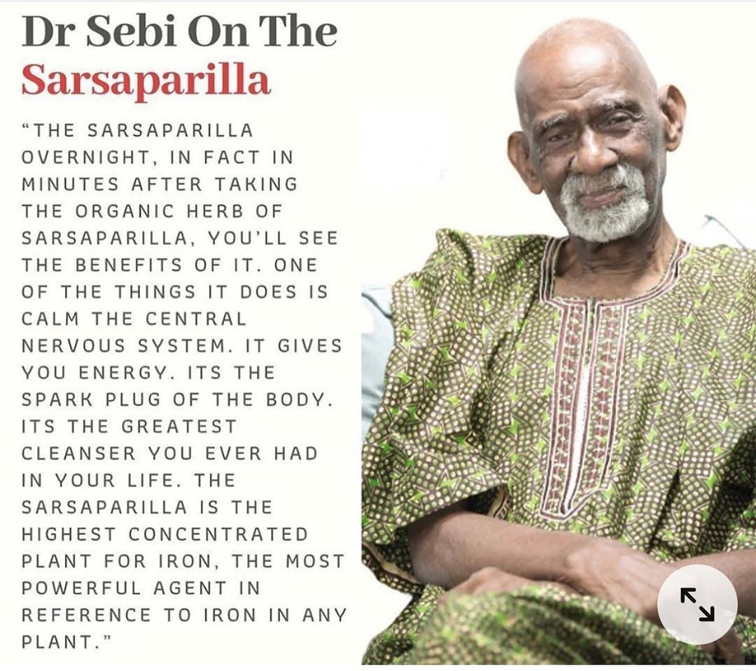 Dr. Sebi wearing a green African-patterned dashiki with text about sarsaparilla.